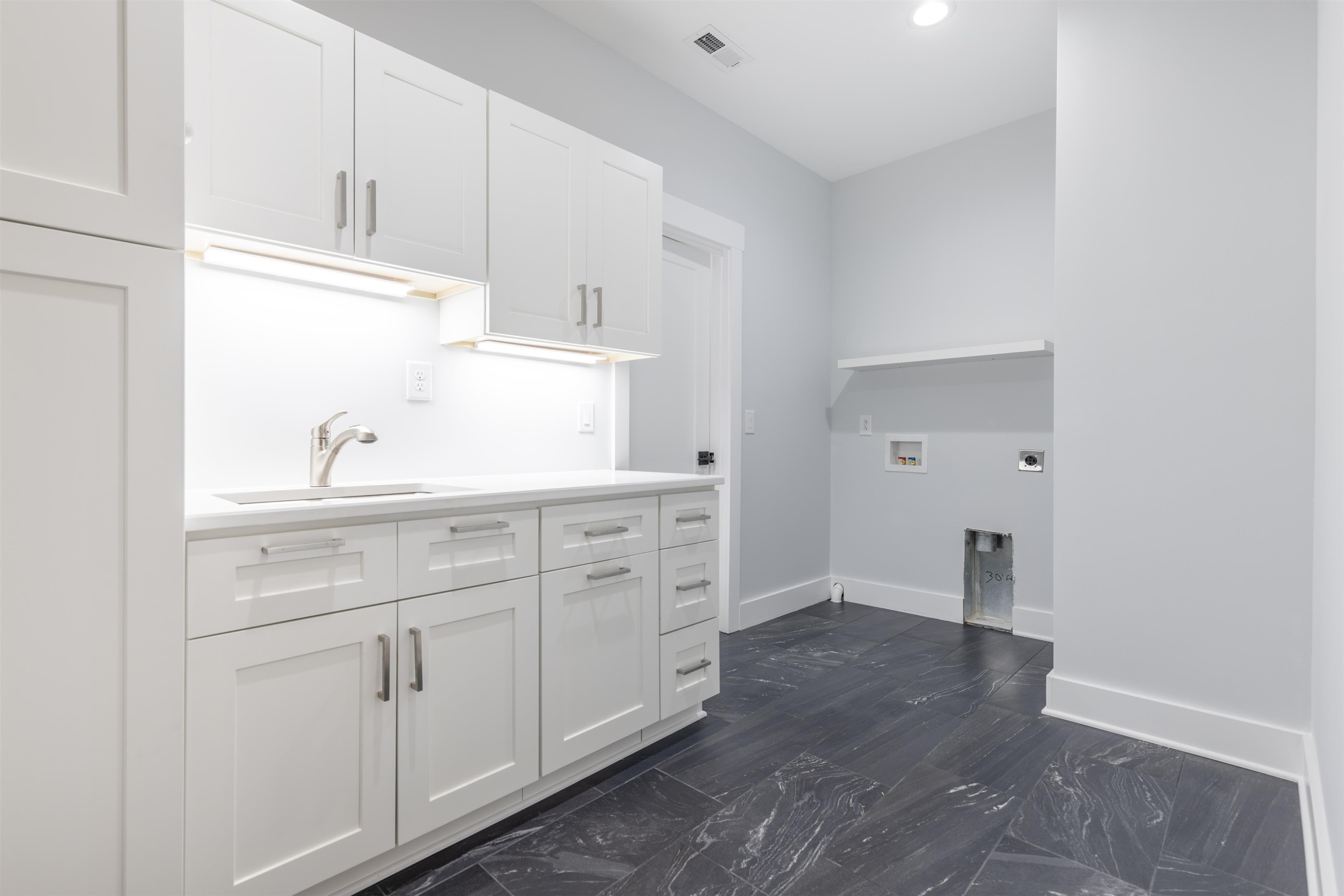 336 Waldo Street Cary, NC 27511 - Photo 29 of 62 a kitchen with white cabinets and sink