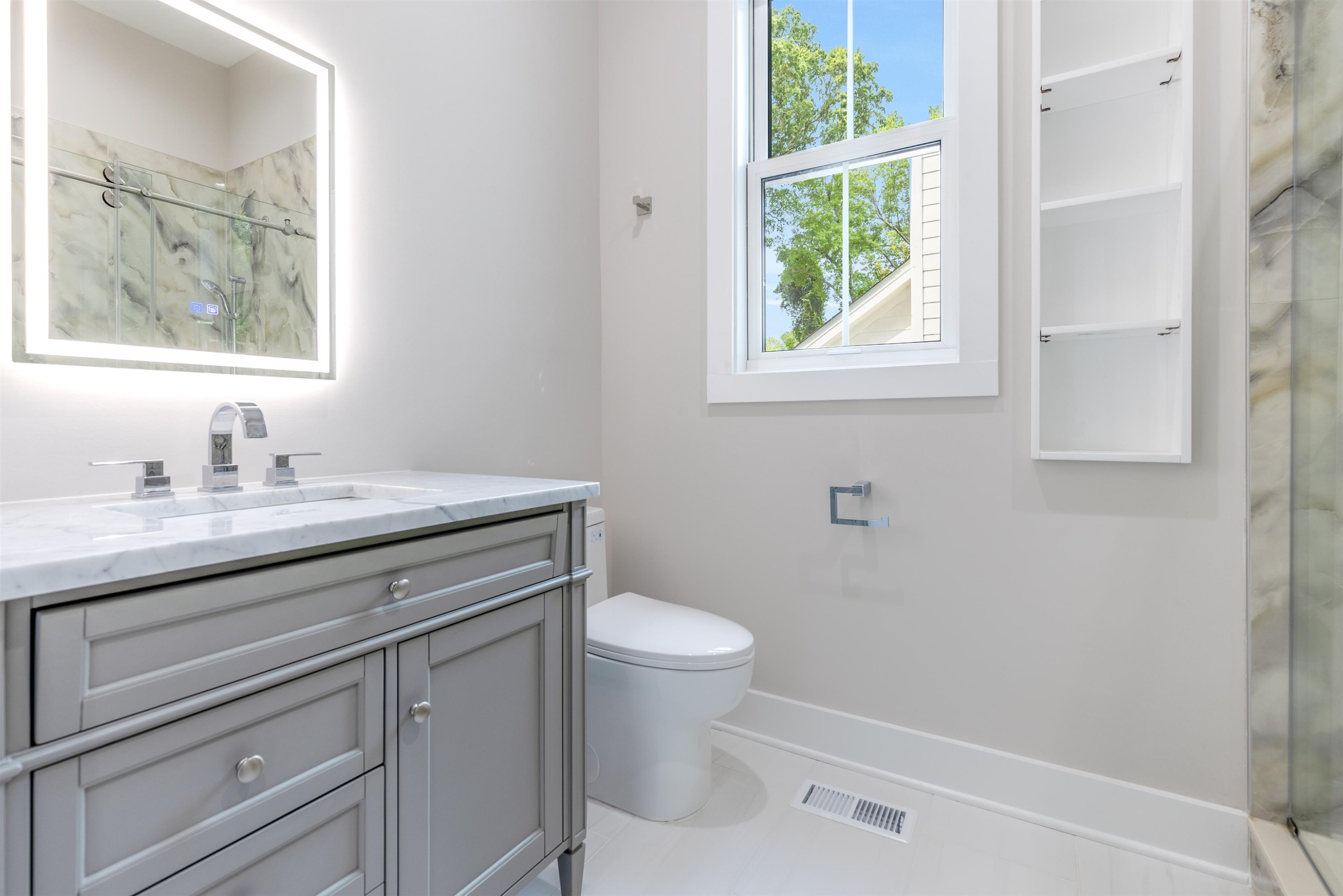 336 Waldo Street Cary, NC 27511 - Photo 35 of 62 a bathroom with a granite countertop toilet a sink a window and mirror