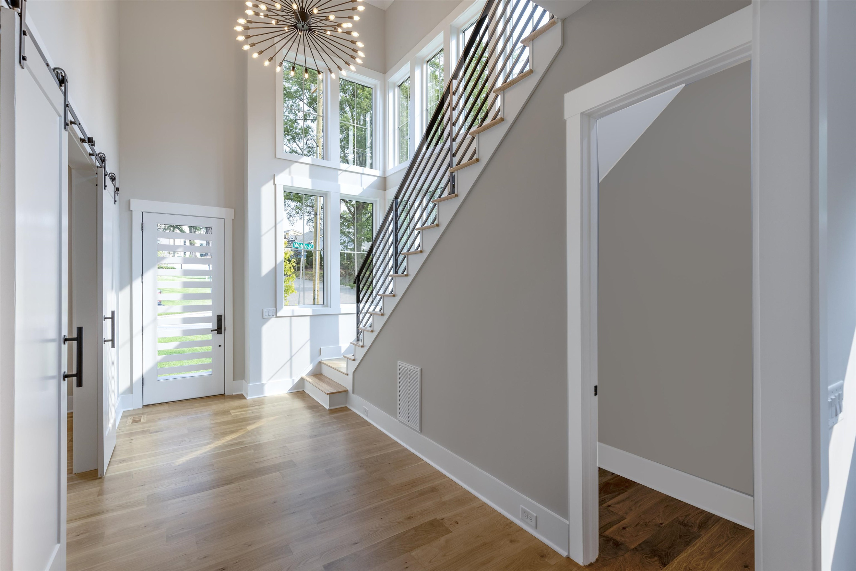 336 Waldo Street Cary, NC 27511 - Photo 4 of 62 a view of entryway with wooden floor and stair