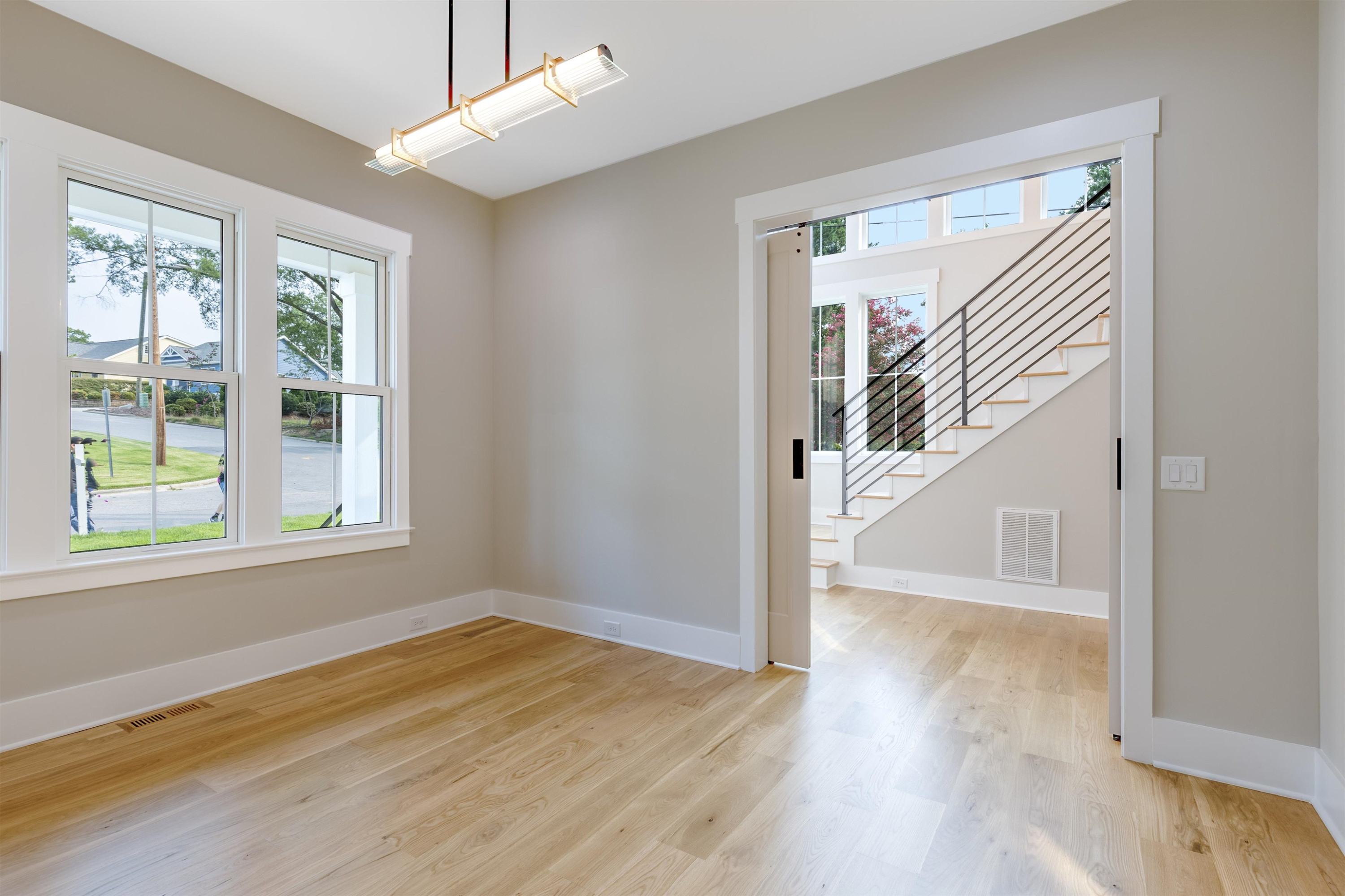 336 Waldo Street Cary, NC 27511 - Photo 7 of 62 a view of empty room with wooden floor and fan