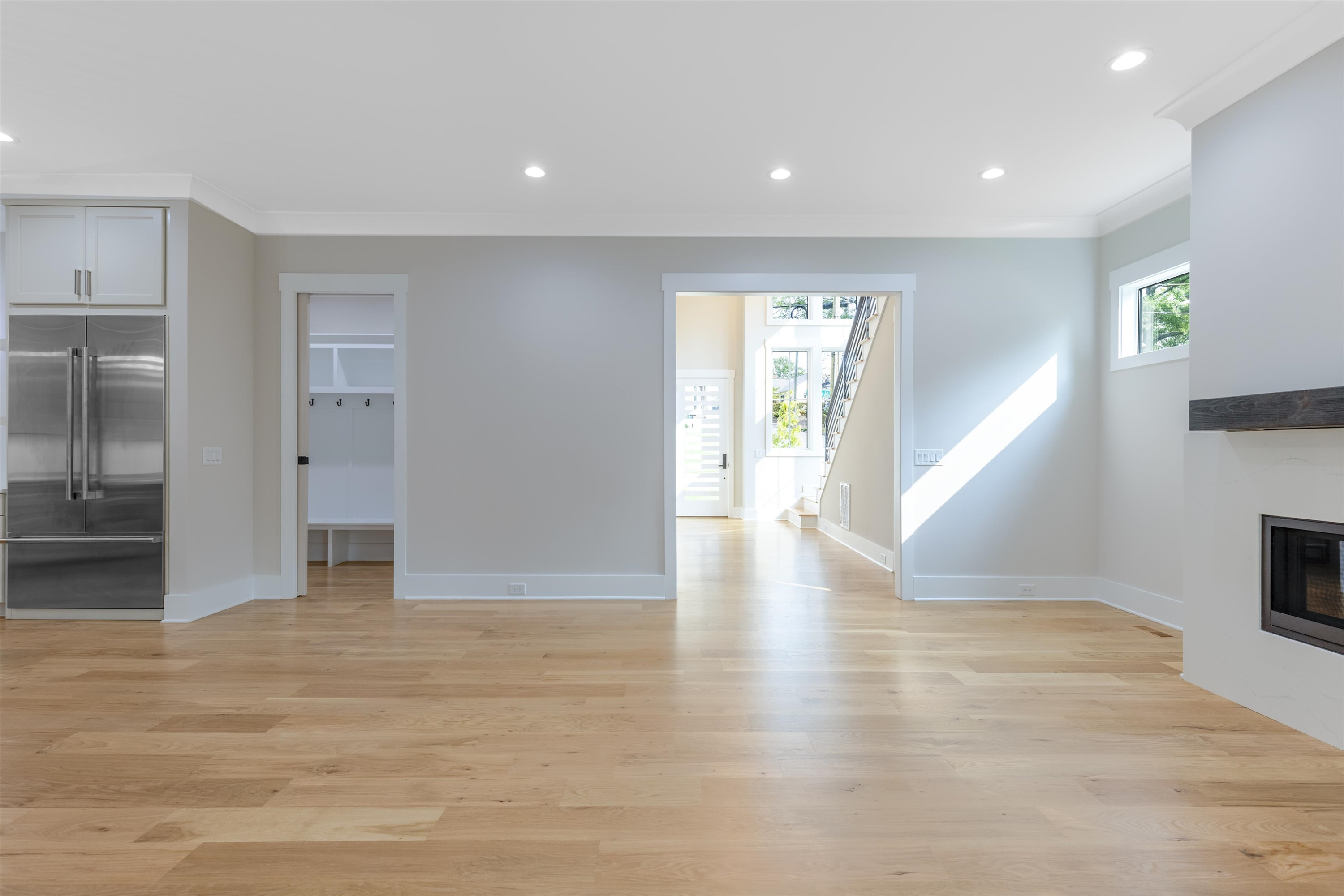 336 Waldo Street Cary, NC 27511 - Photo 9 of 62 a view of an empty room with wooden floor and a kitchen