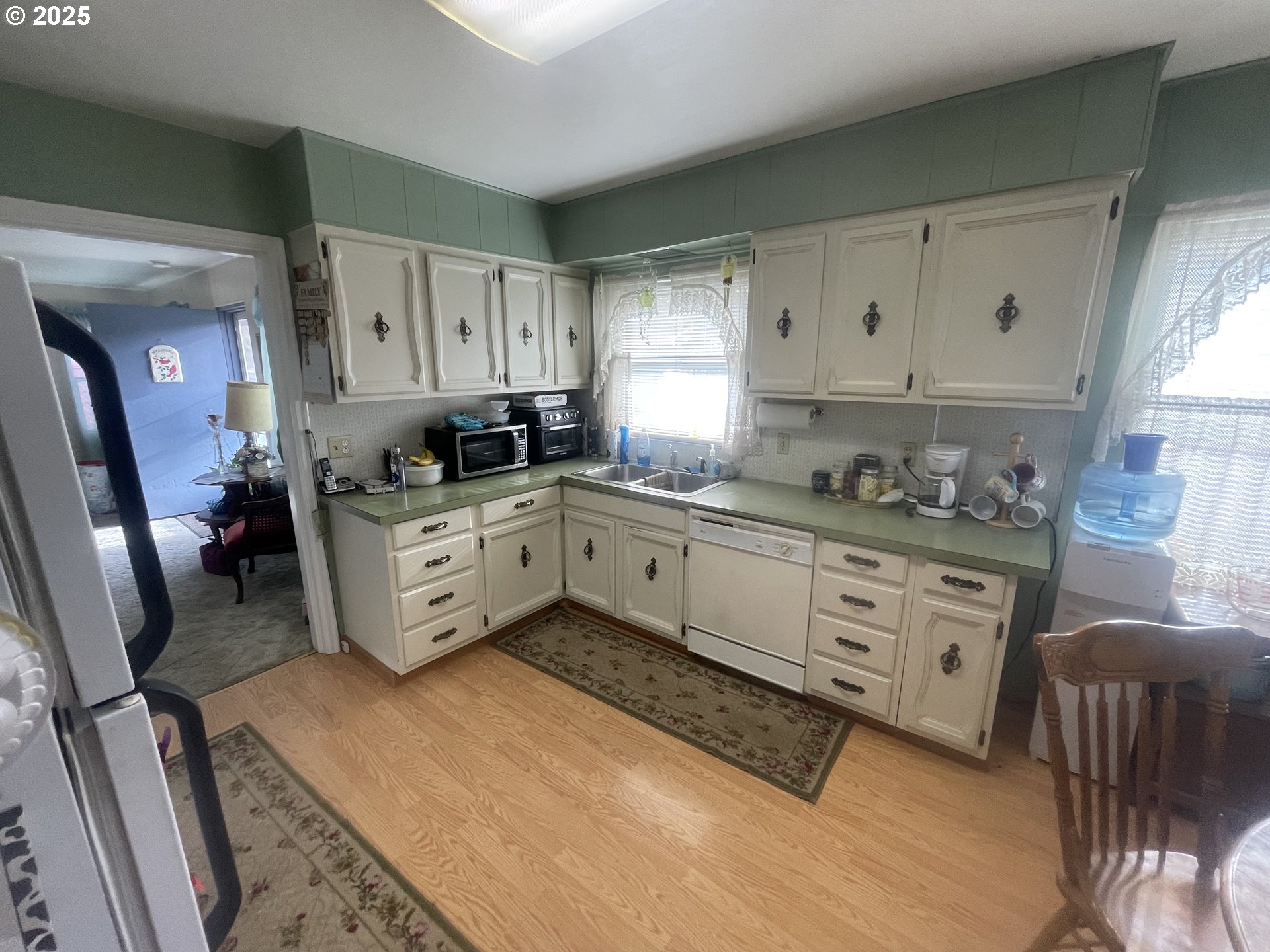 615 South E Hager Street Heppner, OR 97836 - Photo 13 of 14 a kitchen with granite countertop a sink a stove cabinets and wooden floor