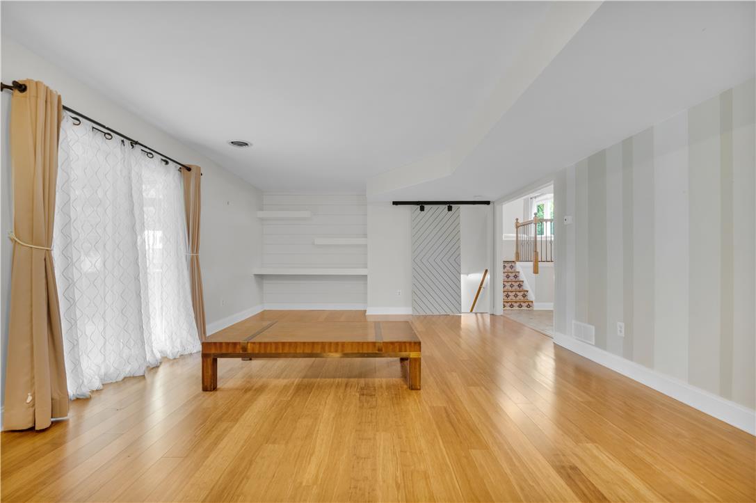 3396 Darien Road Bethlehem, PA 18020 - Photo 9 of 44 Natural light illuminates polished hardwood floors in this spacious, adaptable living area.