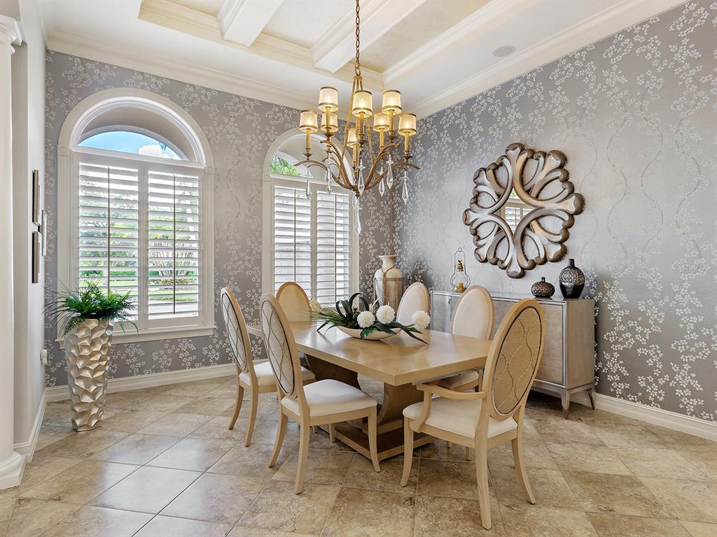 19428 Ganton Avenue Lakewood Ranch, FL 34202 - Photo 12 of 96 a view of a dining room with furniture and chandelier