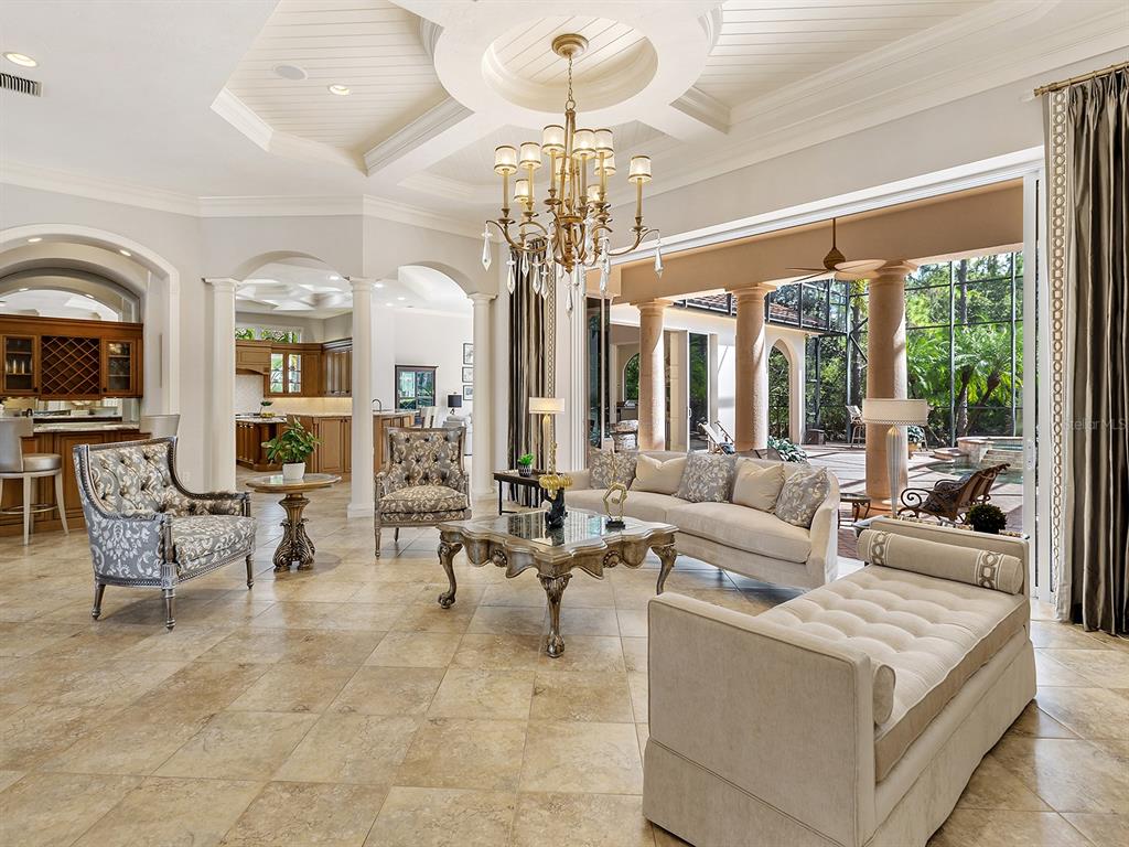 19428 Ganton Avenue Lakewood Ranch, FL 34202 - Photo 20 of 96 a living room with patio furniture and a chandelier