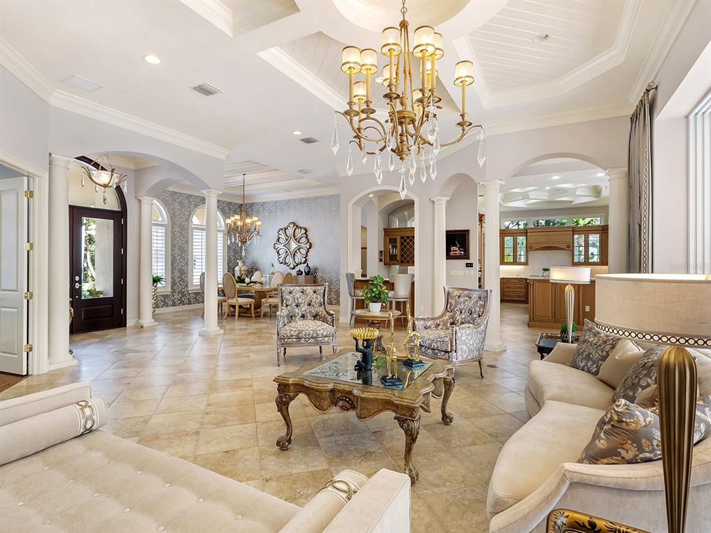 19428 Ganton Avenue Lakewood Ranch, FL 34202 - Photo 21 of 96 a living room with lots of white furniture and chandelier