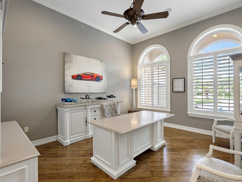 19428 Ganton Avenue Lakewood Ranch, FL 34202 - Photo 38 of 96 a living room with stainless steel appliances kitchen island granite countertop furniture and a flat screen tv