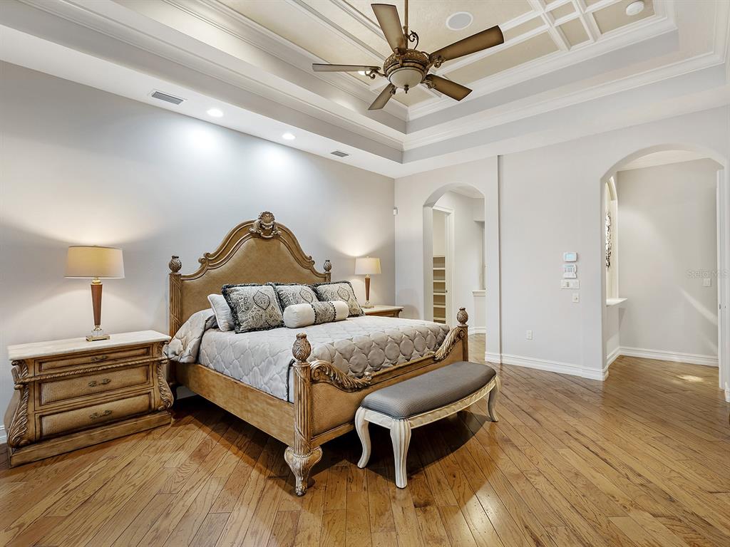 19428 Ganton Avenue Lakewood Ranch, FL 34202 - Photo 42 of 96 a spacious bedroom with a bed and a chandelier