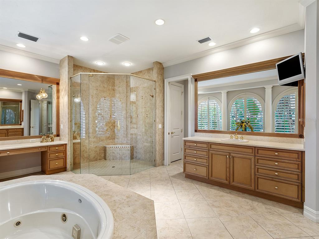 19428 Ganton Avenue Lakewood Ranch, FL 34202 - Photo 45 of 96 a large spacious bathroom with a tub sink shower and mirror