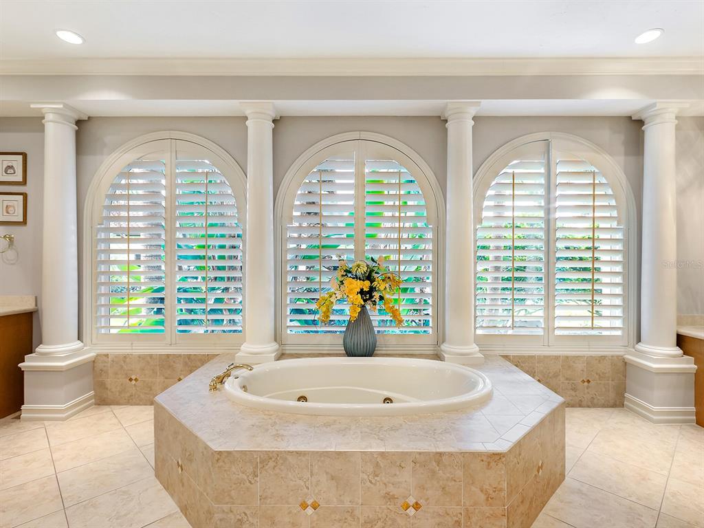 19428 Ganton Avenue Lakewood Ranch, FL 34202 - Photo 46 of 96 a bath tub sitting in a bathroom next to a window