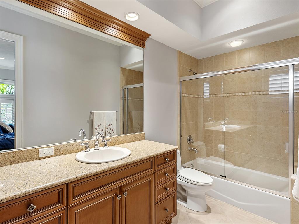 19428 Ganton Avenue Lakewood Ranch, FL 34202 - Photo 51 of 96 a bathroom with a sink toilet vanity and shower
