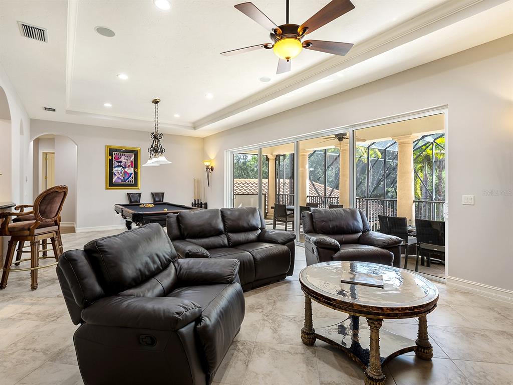 19428 Ganton Avenue Lakewood Ranch, FL 34202 - Photo 62 of 96 a living room with furniture potted plant and a large window