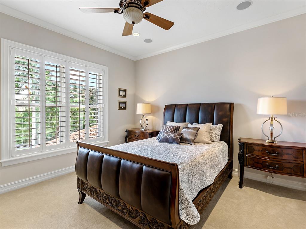 19428 Ganton Avenue Lakewood Ranch, FL 34202 - Photo 68 of 96 a bedroom with a bed and a chandelier