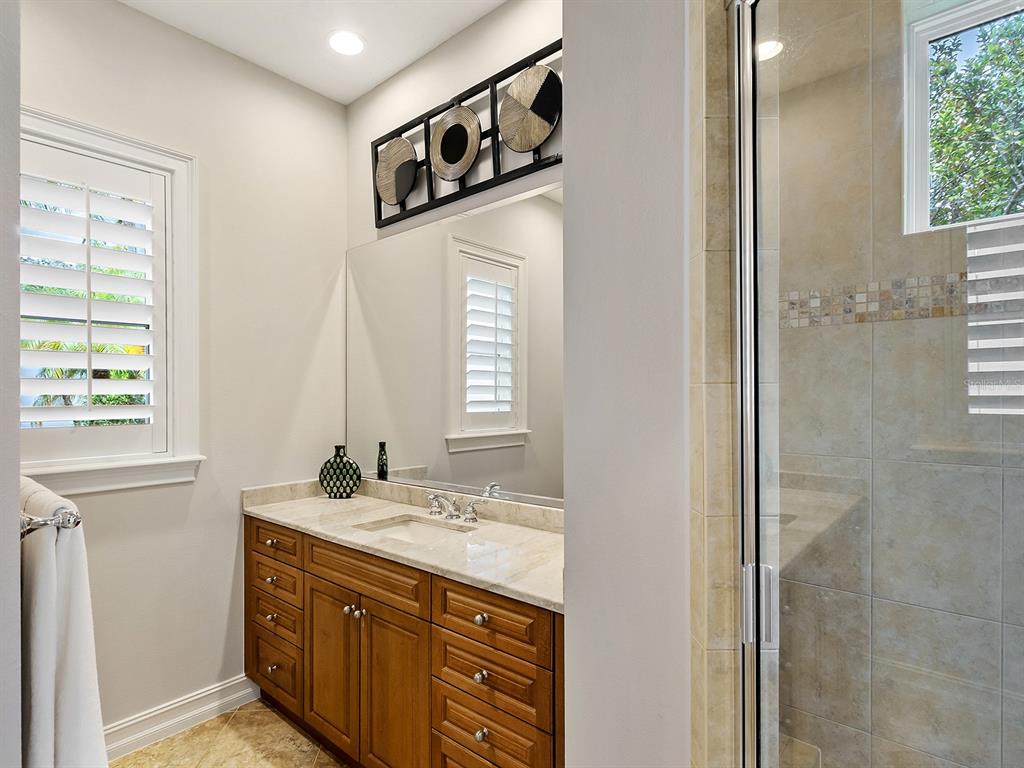 19428 Ganton Avenue Lakewood Ranch, FL 34202 - Photo 69 of 96 a bathroom with a sink a mirror and a window