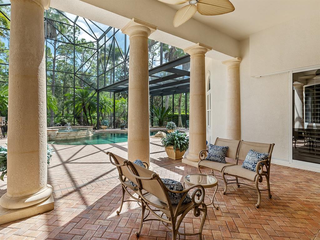 19428 Ganton Avenue Lakewood Ranch, FL 34202 - Photo 70 of 96 a patio with yard glass top table and chairs