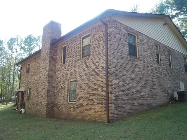 236 Plantation Road Gray, GA 31032 - Photo 15 of 26 a brick building with a bench in front of it