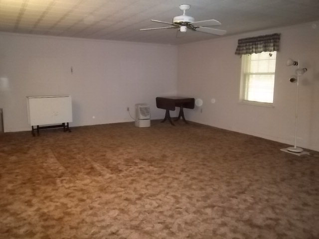 236 Plantation Road Gray, GA 31032 - Photo 17 of 26 an empty room with windows and ceiling fan