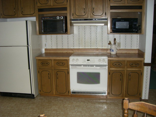 236 Plantation Road Gray, GA 31032 - Photo 23 of 26 a kitchen with cabinets stainless steel appliances and wooden floor