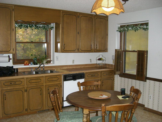 236 Plantation Road Gray, GA 31032 - Photo 24 of 26 a kitchen with a table chairs sink and cabinets