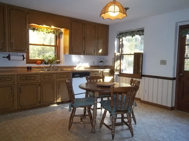 236 Plantation Road Gray, GA 31032 - Photo 5 of 26 a kitchen with a table chairs sink and cabinets