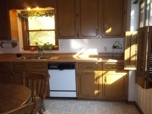 236 Plantation Road Gray, GA 31032 - Photo 7 of 26 a kitchen with a sink appliances cabinets and a window