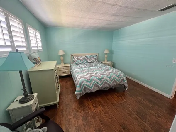 a view of a room with wooden floor