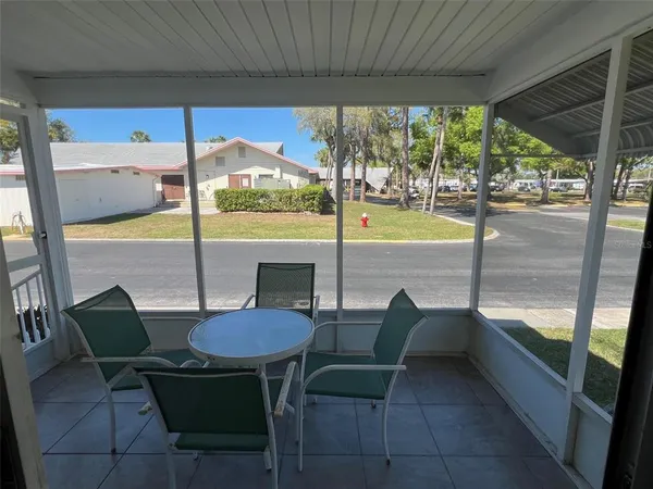 a view of a patio with a table chairs and a tub