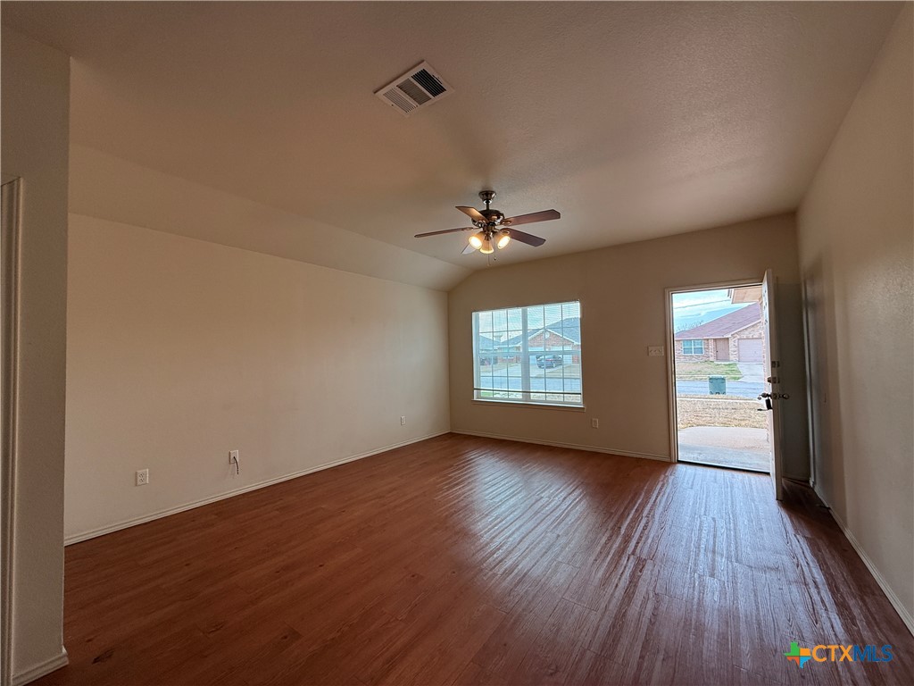 6210 Temora Loop, Unit B Killeen, TX 76549 - Photo 2 of 11 a view of an empty room with wooden floor and a window