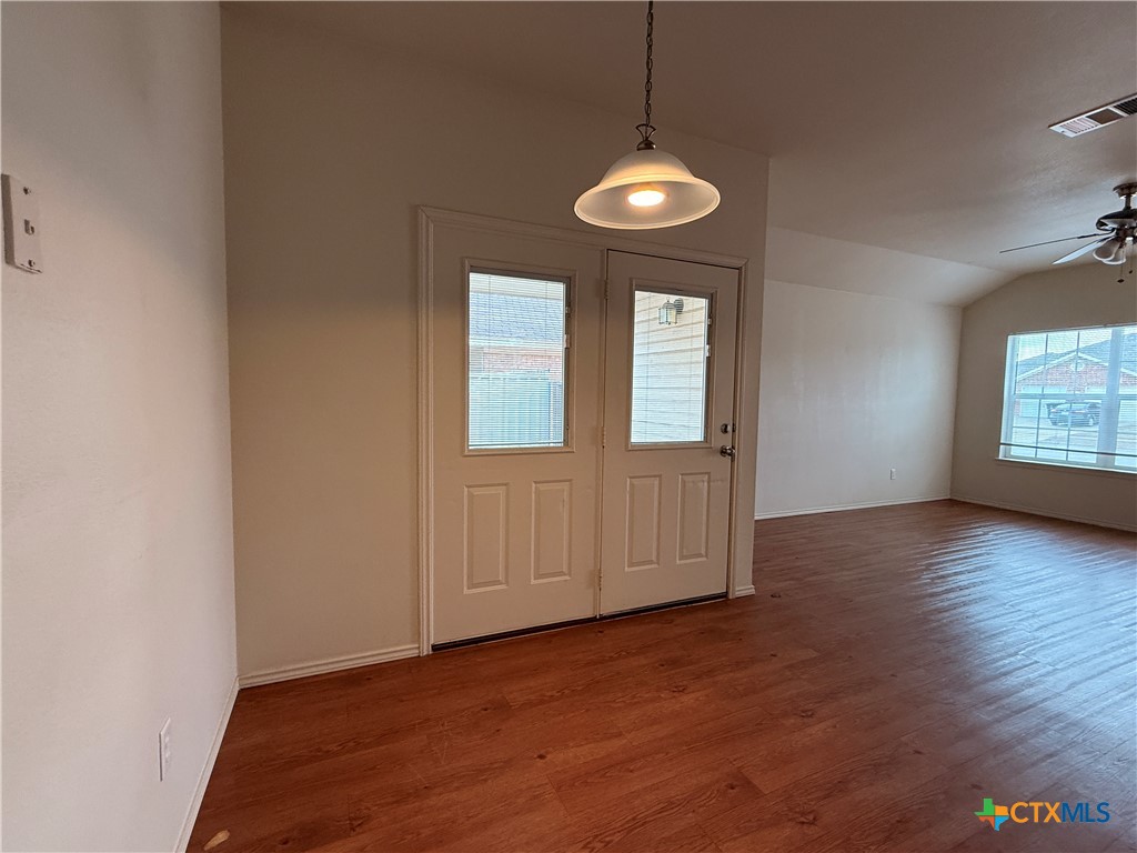 6210 Temora Loop, Unit B Killeen, TX 76549 - Photo 3 of 11 an empty room with wooden floor and windows