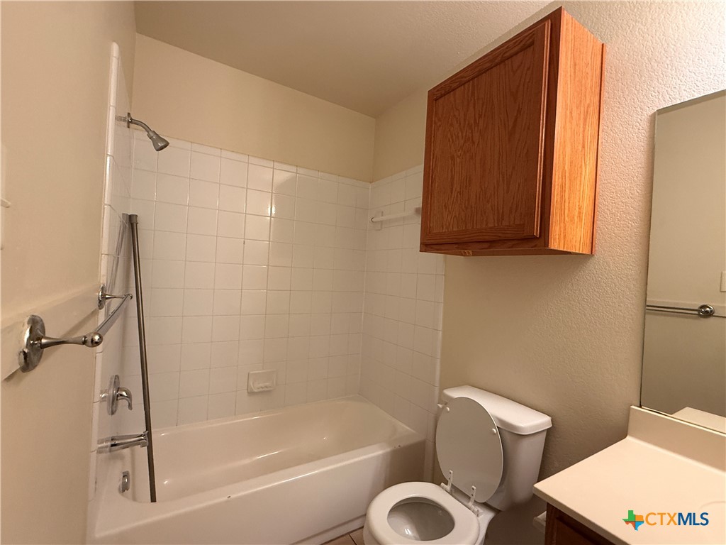 6210 Temora Loop, Unit B Killeen, TX 76549 - Photo 6 of 11 a bathroom with a shower a toilet and a bathtub