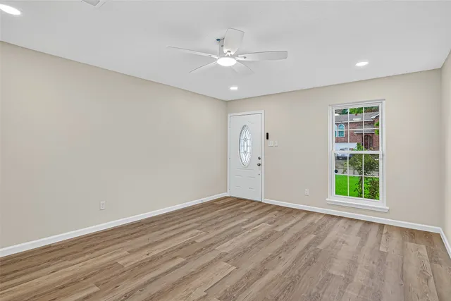 wooden floor in an empty room with a window