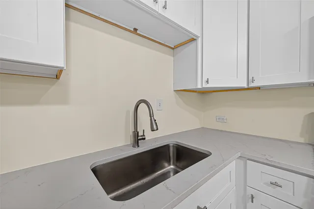 a kitchen with a sink and cabinets