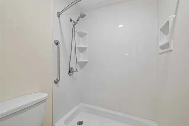 a bathroom with a shower and a toilet