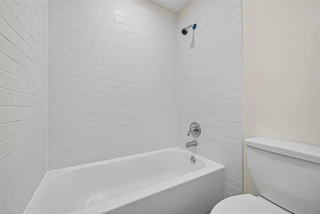 a bathroom with a toilet and bathtub