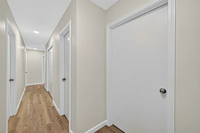 a view of a hallway with wooden floor