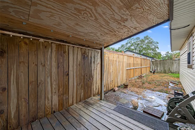 a view of a backyard with wooden fence