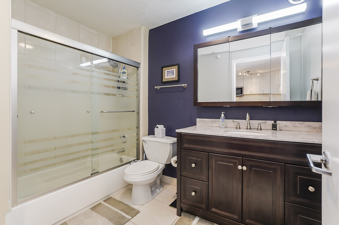 545 North Dearborn Street, Unit 2510 Chicago, IL 60654 - Photo 12 of 22 a bathroom with a granite countertop sink toilet a large mirror and shower