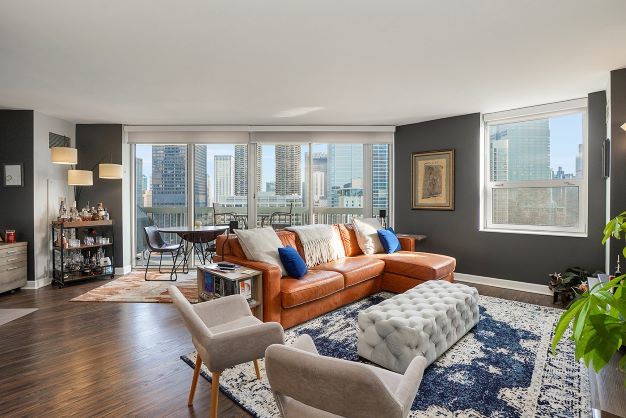 545 North Dearborn Street, Unit 2510 Chicago, IL 60654 - Photo 2 of 22 a living room with furniture and floor to ceiling windows