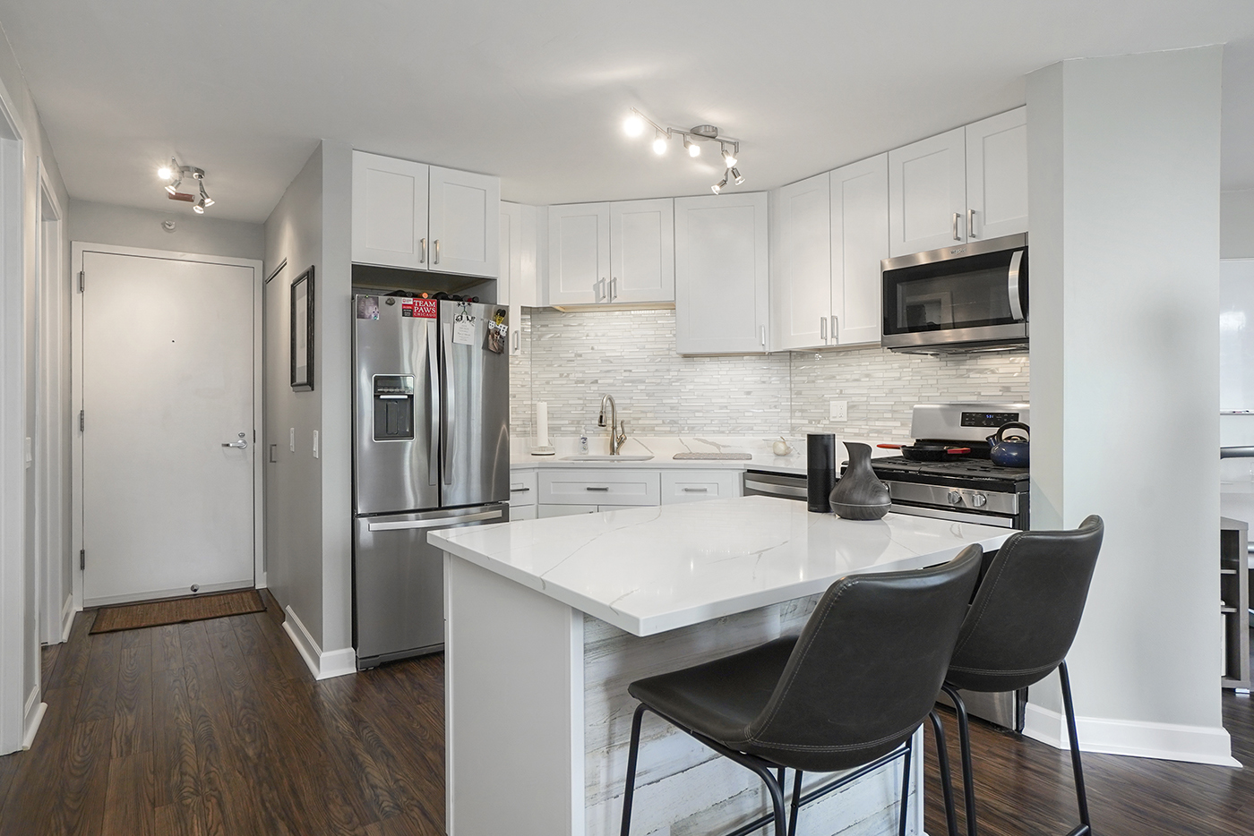 545 North Dearborn Street, Unit 2510 Chicago, IL 60654 - Photo 7 of 22 a kitchen with stainless steel appliances a refrigerator stove microwave and cabinets