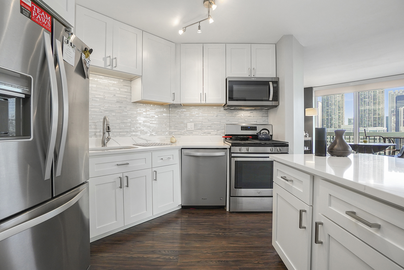 545 North Dearborn Street, Unit 2510 Chicago, IL 60654 - Photo 8 of 22 a kitchen with cabinets stainless steel appliances and a counter space