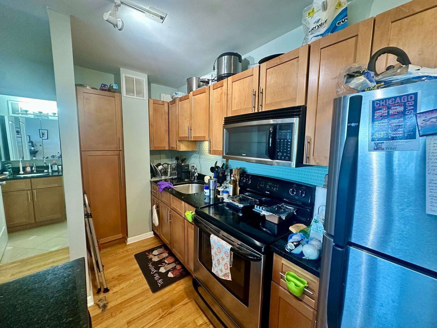 4180 North Marine Drive, Unit 1608 Chicago, IL 60613 - Photo 2 of 11 a kitchen with stainless steel appliances granite countertop a stove a refrigerator and a microwave