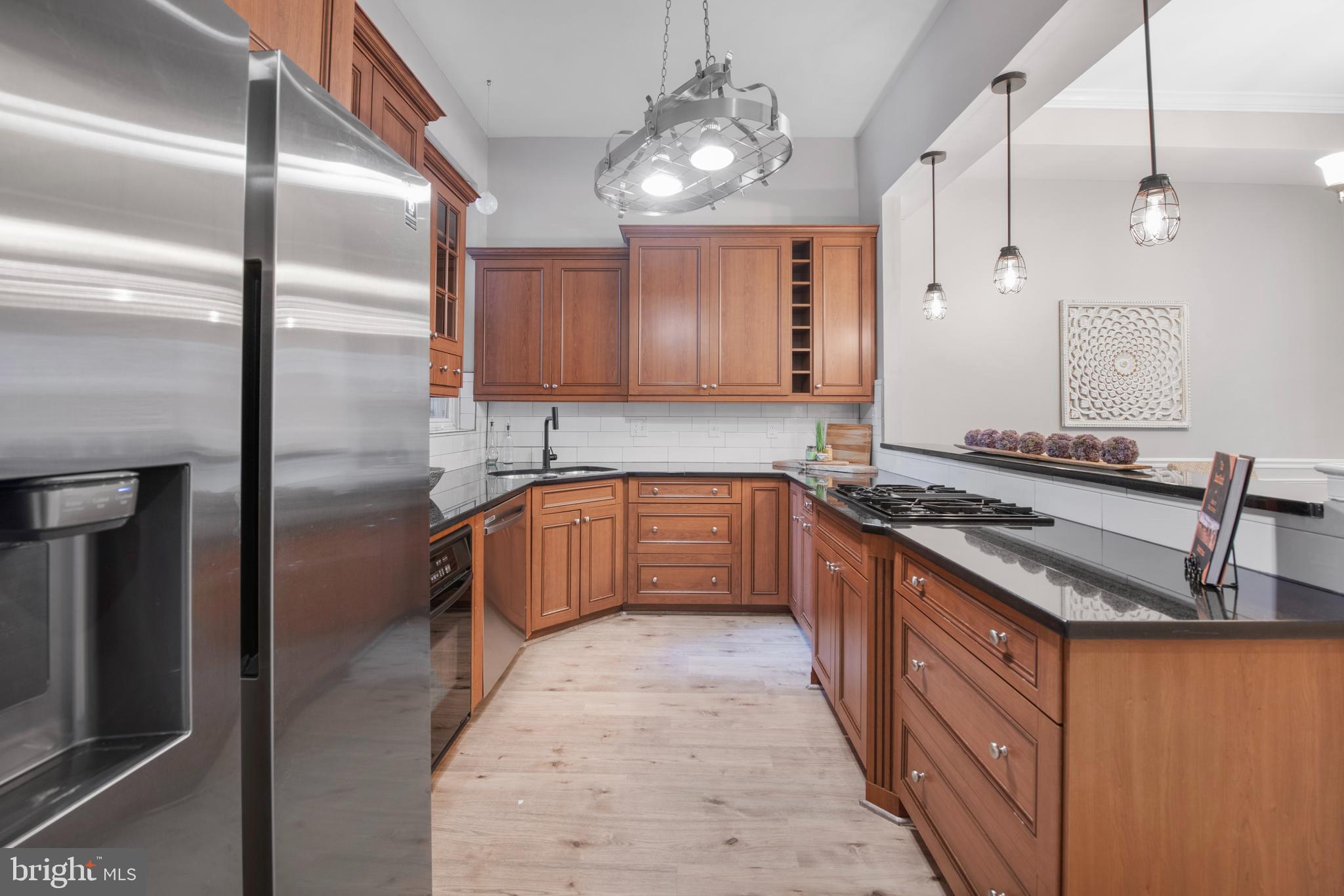 903 R Street Northwest, Unit 1 Washington, DC 20001 - Photo 12 of 32 a kitchen with stainless steel appliances granite countertop a sink a stove and a refrigerator