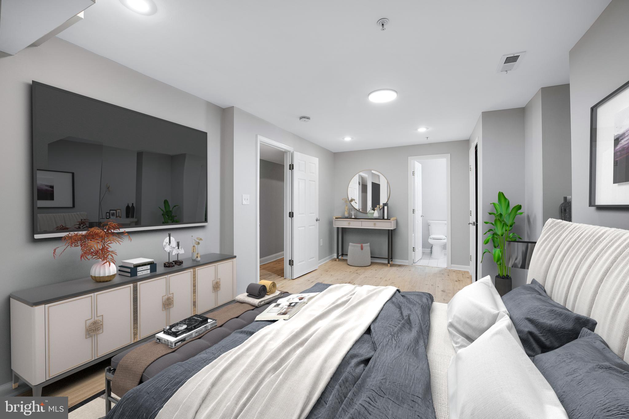 903 R Street Northwest, Unit 1 Washington, DC 20001 - Photo 21 of 32 a spacious bedroom with a bed a couch and a view of kitchen