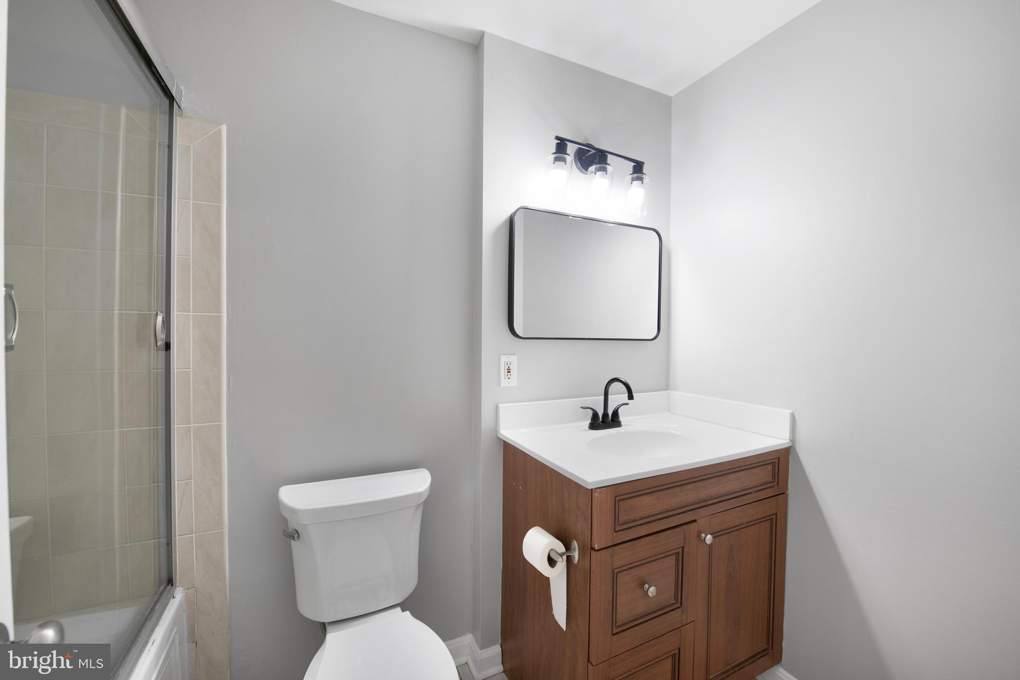 903 R Street Northwest, Unit 1 Washington, DC 20001 - Photo 22 of 32 a bathroom with a toilet sink and mirror