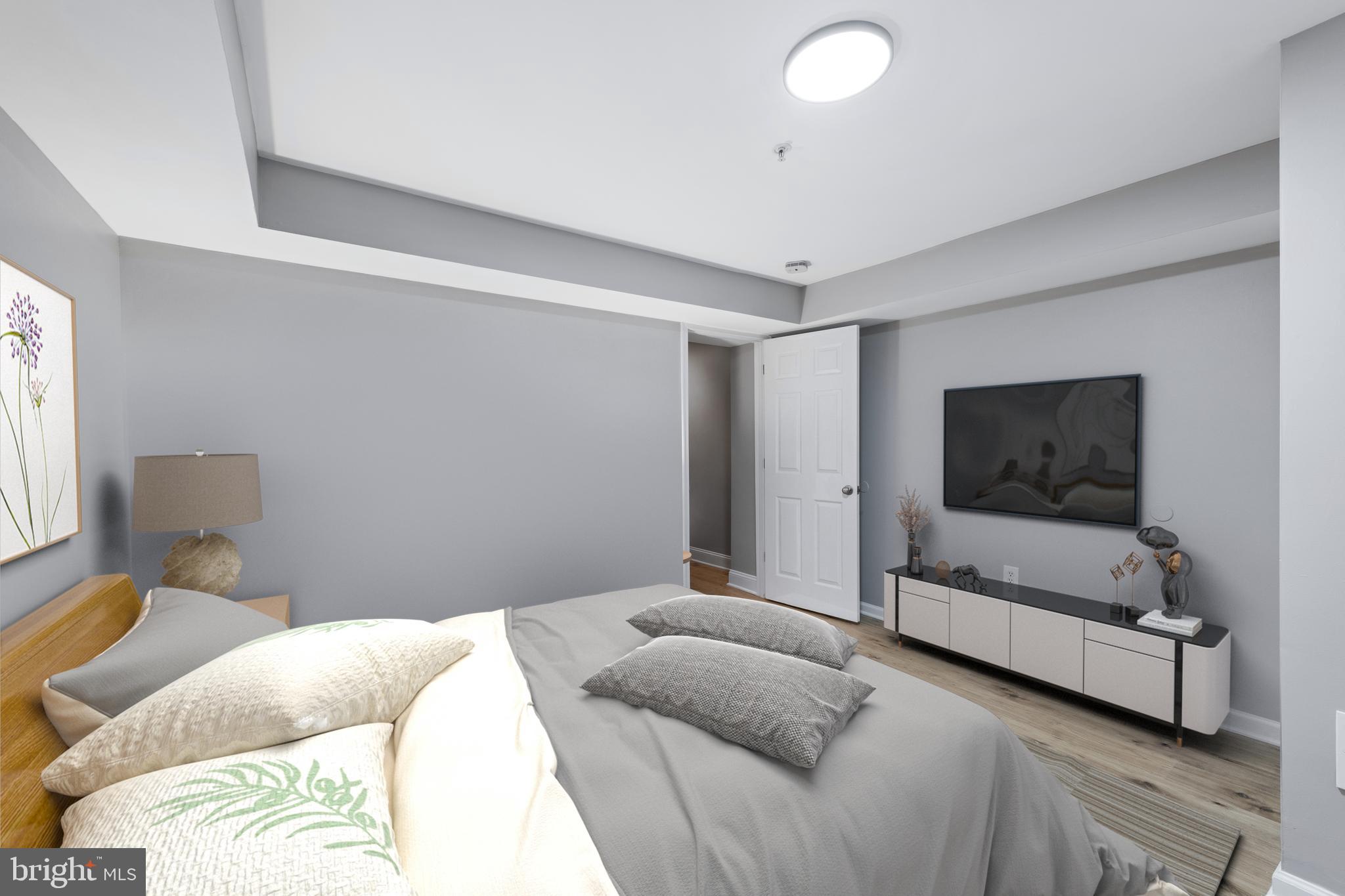 903 R Street Northwest, Unit 1 Washington, DC 20001 - Photo 27 of 32 a bedroom with a bed and a flat screen tv