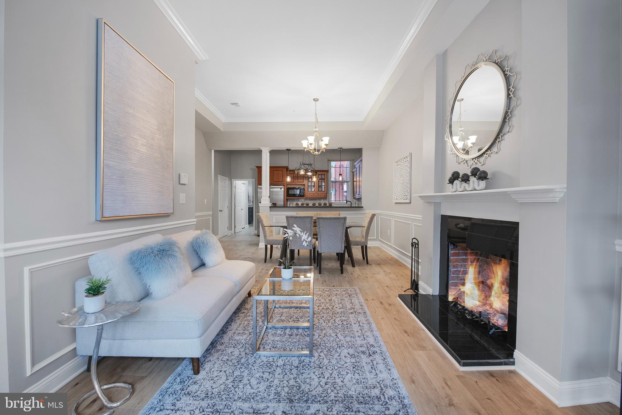 903 R Street Northwest, Unit 1 Washington, DC 20001 - Photo 4 of 32 a living room with furniture a fireplace and a chandelier