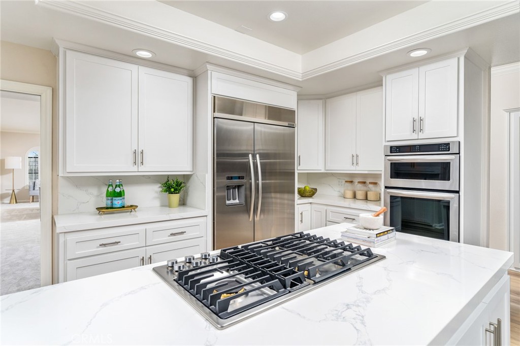 1187 Edinburgh Road San Dimas, CA 91773 - Photo 12 of 57 a kitchen with a stove a sink and a refrigerator