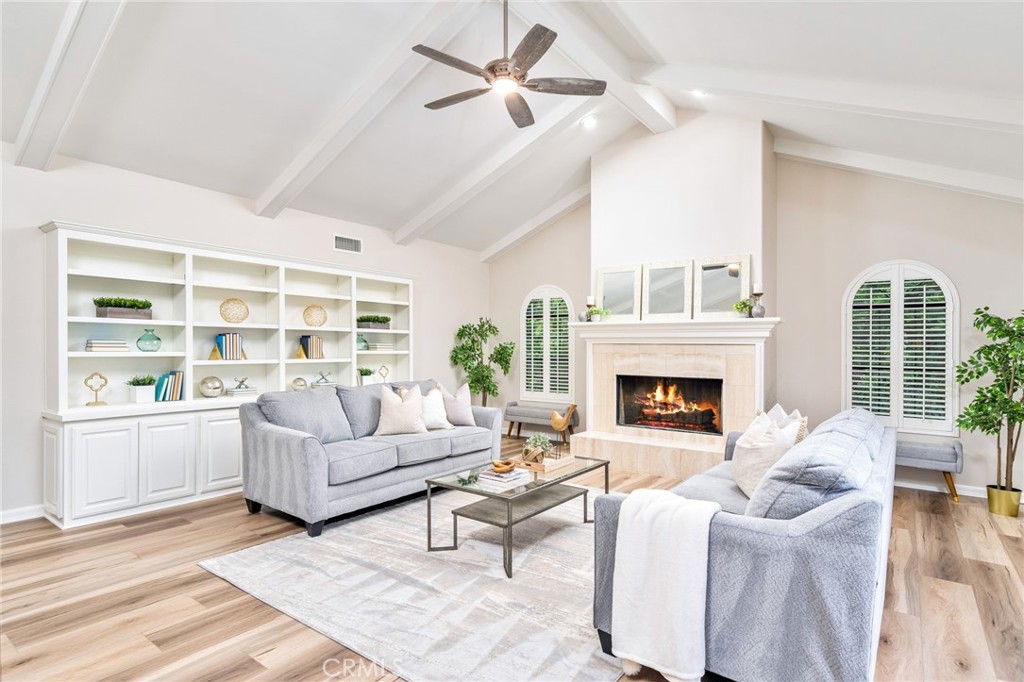1187 Edinburgh Road San Dimas, CA 91773 - Photo 16 of 57 a living room with furniture a fireplace and a large window