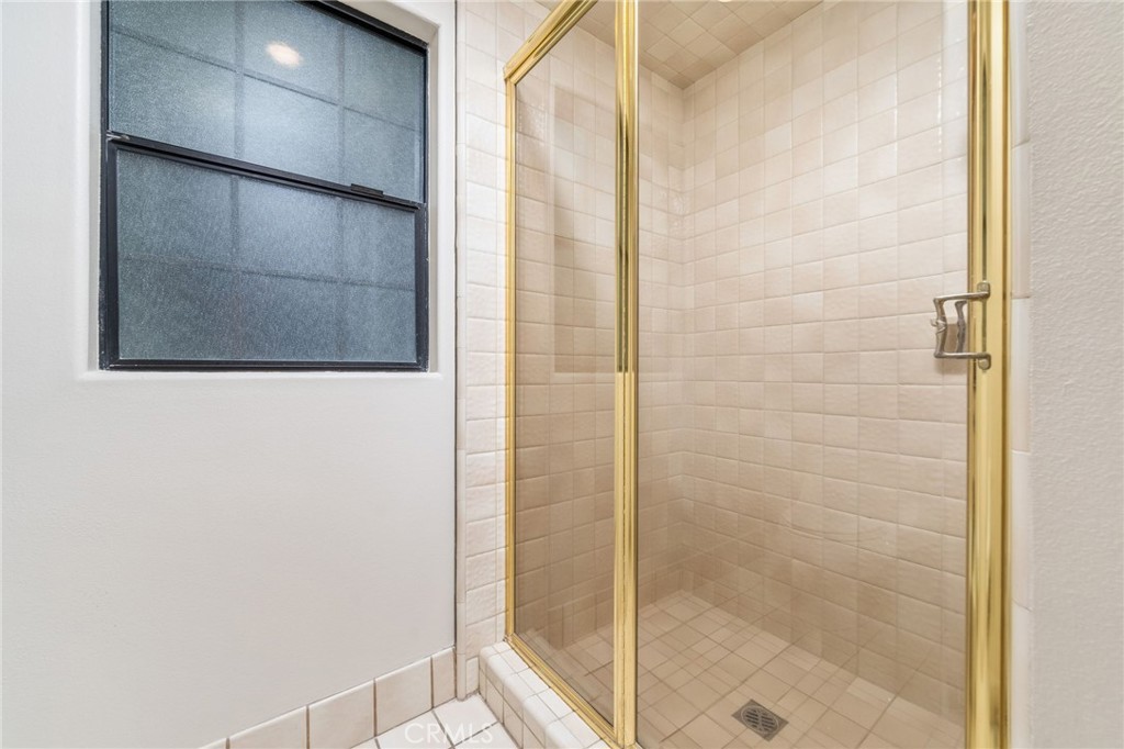 1187 Edinburgh Road San Dimas, CA 91773 - Photo 31 of 57 a bathroom with a shower and a glass door