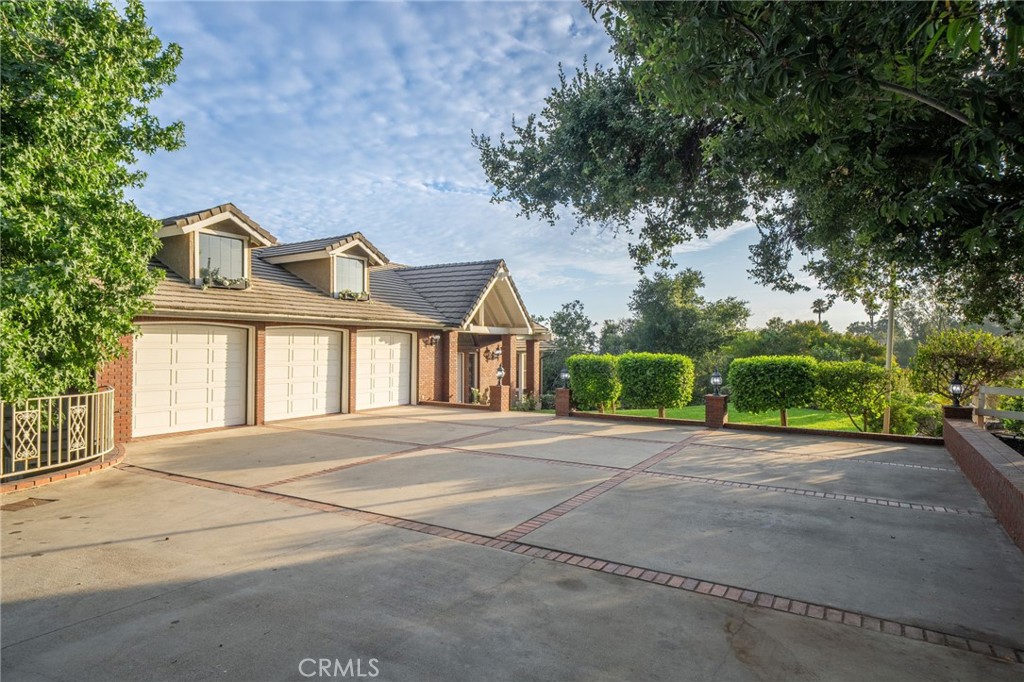 1187 Edinburgh Road San Dimas, CA 91773 - Photo 39 of 57 a front view of a house with a yard and garage